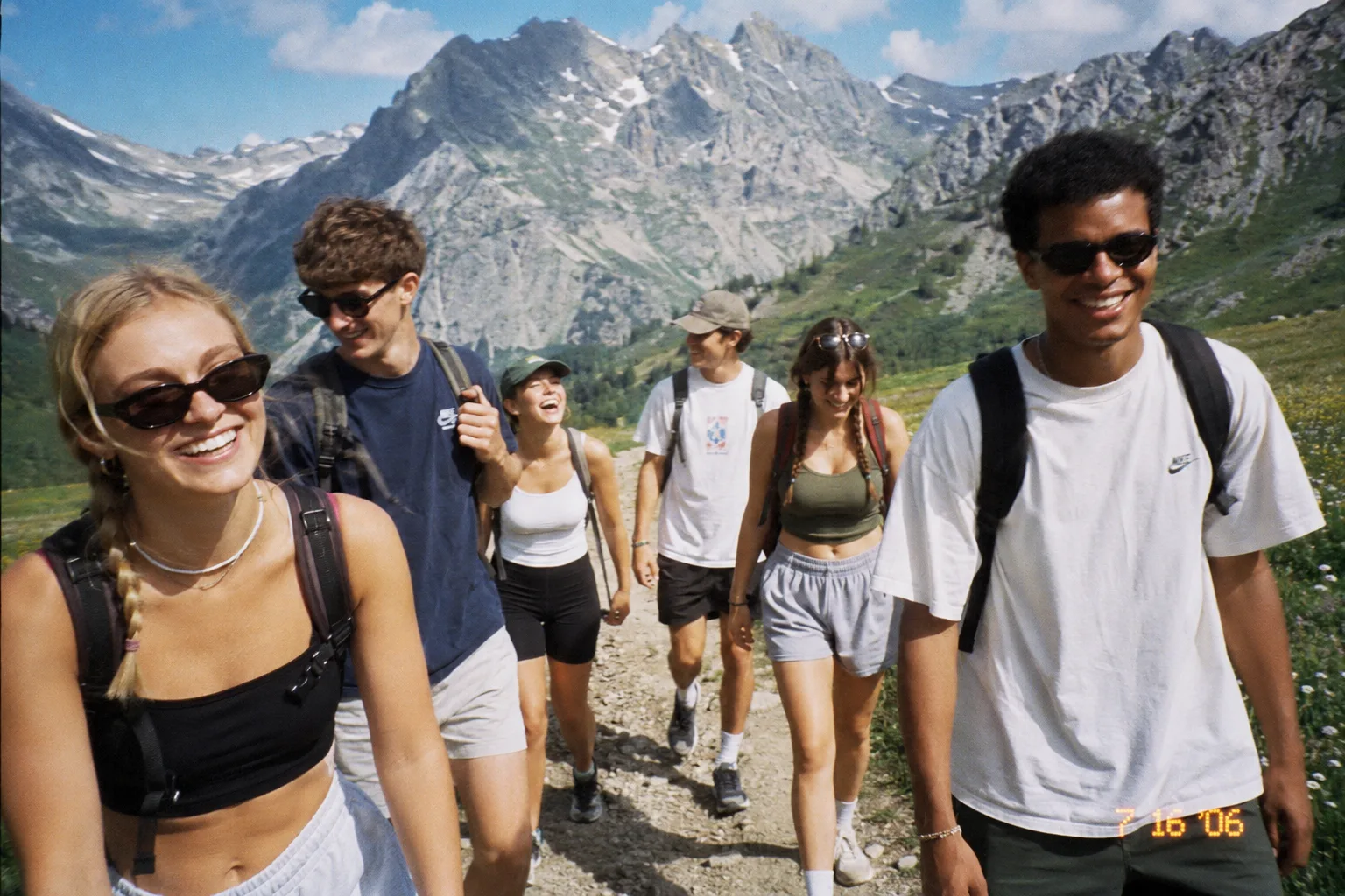 Friends walking up a bright alpine trail