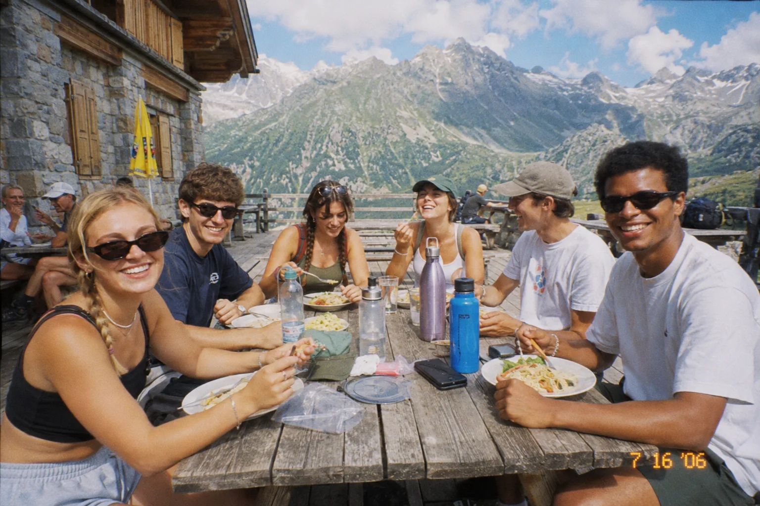 Friends sharing a casual mountain hut lunch